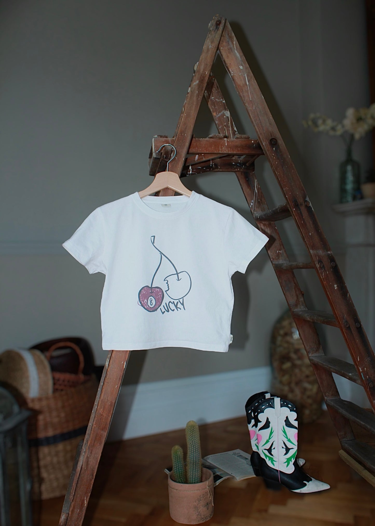 SUPERSTITIOUS CHERRY WHITE BABY TEE